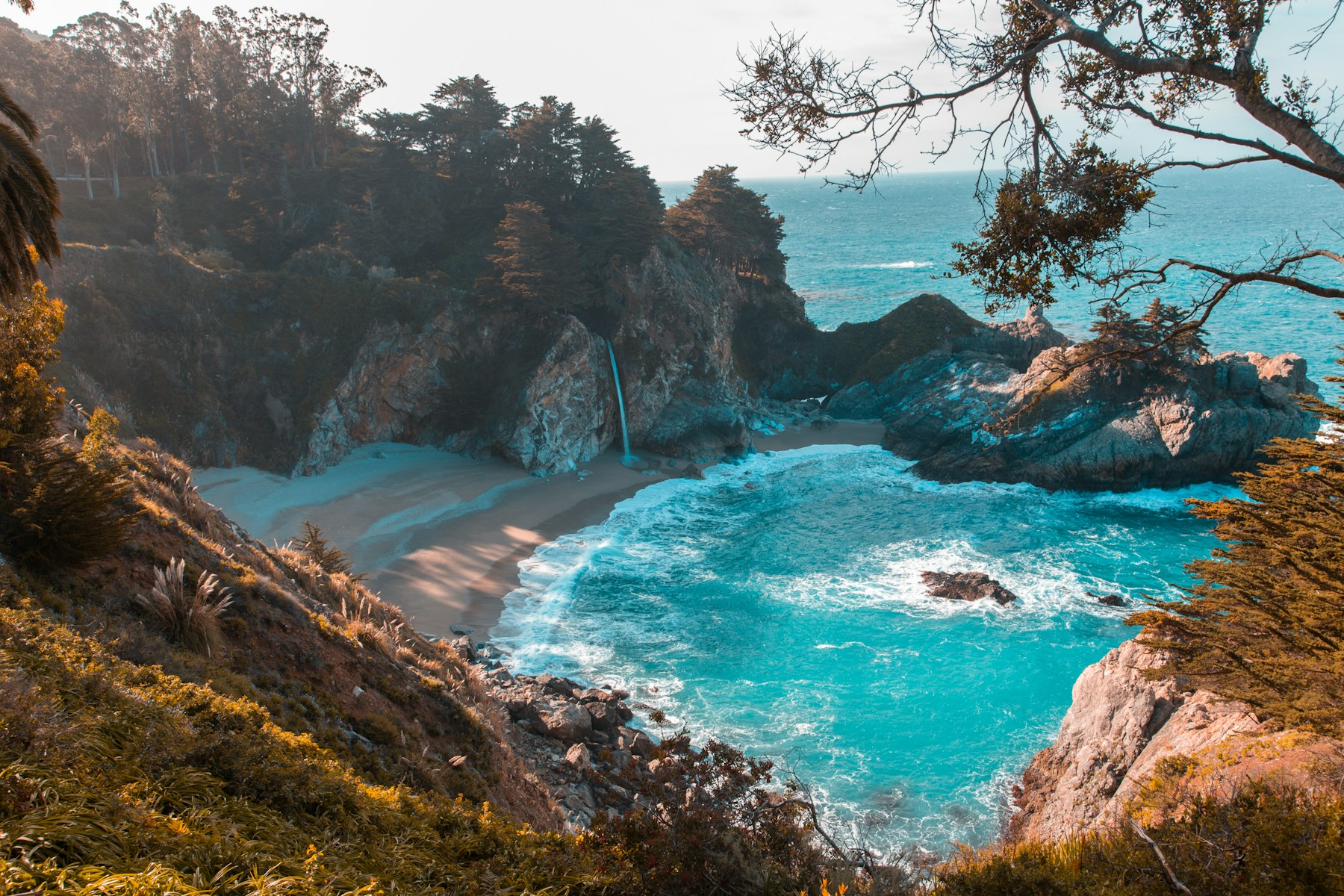 Turquoise water meeting a secluded coastal cove